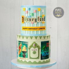 a three tiered birthday cake decorated with disney land images and the words happy birthday lanny