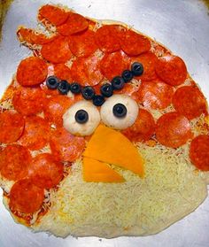 the pizza has been made to look like an angry bird with pepperoni on it