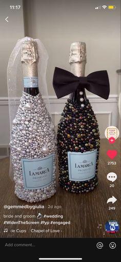 two bottles of wine are sitting next to each other on a table with a black bow tie