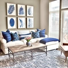 a living room filled with furniture and pictures on the wall above it's coffee table