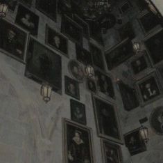 the ceiling is covered with many framed pictures