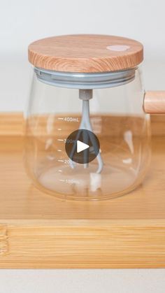 a wooden lid on a glass coffee pot