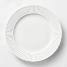 an empty white plate on a white surface