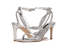 Nine West Tallo 3 - Women's Shoes : Silver : Feel like an absolute diva when you slay in the sexy Nine West Tallo 3 strappy sandals. Faux leather upper. Man-made lining. Open square toe. Metallic chain embellishment. High heels. Ankle strap with buckle closure. Man-made outsole. Imported. Weight of footwear is based on a single item, not a pair. Trendy Evening Sandals With Straps, Trendy Formal Sandals With Straps, Chain Strap Open Toe Sandals For Night Out, Spring Ankle Strap Sandals With Chain Strap, Trendy Chain Strap Sandals For Party, Open Toe Heels With Chain Strap For Party, Ankle Strap Heels With Chain Strap For Party, Chain Strap Open Toe Party Heels, Chain Strap Open Toe Heels For Parties