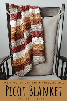 a crocheted blanket sitting on top of a wooden chair next to a pillow