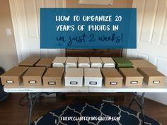 a table with boxes on it and a sign that says how to organize 20 years of photos in just 2 weeks