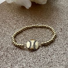 Hit a fashion home run with our Softball 14k Gold Beaded Bracelet, a chic accessory for softball players, softball moms or coaches who appreciate a touch of elegance. Adorned with fine gold beads, is the perfect way to celebrate your passion for softball, adding a glamorous twist to your sporty spirit. 🥎 HIGH-QUALITY MATERIALS- Made with 4mm, 14kt gold-filled beads- Worry-free wear‚ which means sleep, shower and sweat in it- Stacks well with all bracelets SIZEAdjustable - Hand beaded on high pe Adjustable Gold Beaded Bracelets For Game Day, Softball Bracelet, Team Bracelets, Gold Beaded Bracelet, Mom Keychain, Sports Bracelet, Softball Players, Gold Bead Bracelets, Home Run