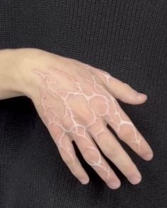 a person's hand with white paint on it