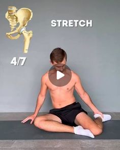 a man sitting on top of a yoga mat in front of a sign that says stretch