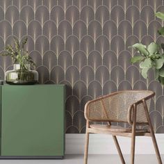 a green cabinet sitting next to a wall with an art deco design on the side