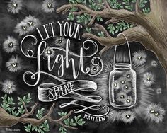 a chalkboard drawing with the words, let your light shine in front of a tree