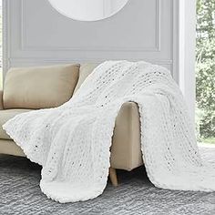 a couch with a white blanket on top of it