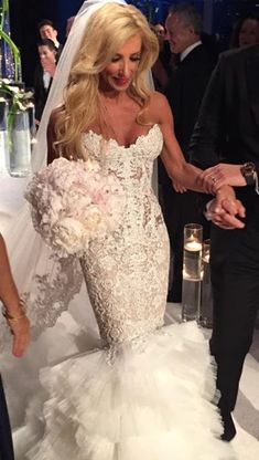 the bride and groom are walking down the aisle at their wedding reception, holding hands