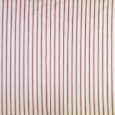 a red and white striped shirting fabric with small black dots on the bottom half