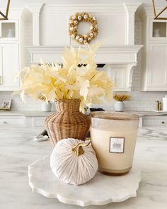 a candle and some flowers in a vase on a table