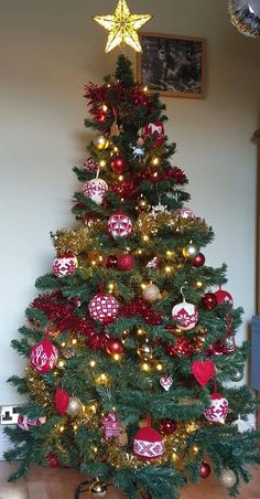 a decorated christmas tree with red and gold ornaments