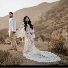 a man and woman holding hands in the desert