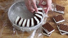 someone decorating cookies with chocolate and marshmallows