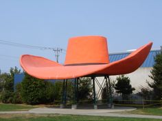 an orange hat sitting on top of a metal pole