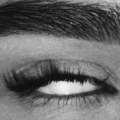 black and white photograph of an eye with long lashes