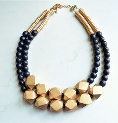 "A beaded multi strand statement necklace made with black and gold wood beads. The necklace is light weight. - 2 strands - Gold bead size is .75\" - Shortest strand 20.5-22.5\" (length can be customized) - Clasp is gold stainless steel and (gold filled, stainless steel or sterling silver clasps are also available) - Connector is lead free pewter The mannequin's neck size is 15\". The necklace can be made with more/less strands. Larger quantities may be available. Available in these colors as wel Wood Beads Jewelry, Blue Statement Necklace, Chunky Bead Necklaces, Silver Jewelry Box, Wood Bead Necklace, Necklace Chunky, Wooden Necklace, Gold Statement Necklace, Chunky Beads