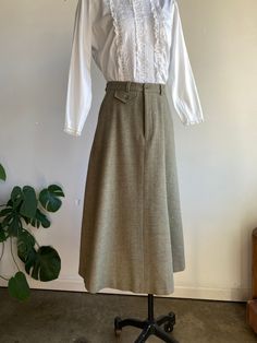 "Vintage 80s Herringbone Wool Maxi Skirt by Ralph Lauren. Sage green in color with a herringbone pattern, made from 100% wool in the USA. Skirt features a front zip and button closure and additional pockets on front and back. Conditon overall is excellent with no noted flaws. Skirt shows very light signs of wear. Please see all photos for details. Refer to measurements below to ensure a proper fit (modeled on a size small mannequin) 13\" across waist (26\") 33\" in total length (waist line to bo Spring Long Wool Skirt, Vintage Fall Workwear Skirt, Vintage Workwear Skirt For Fall, Fall Vintage Workwear Skirt, Vintage Wool Lined Skirt, Fall Vintage Skirt For Workwear, Wool Maxi Skirt, Long Wool Skirt, Long Wrap Skirt