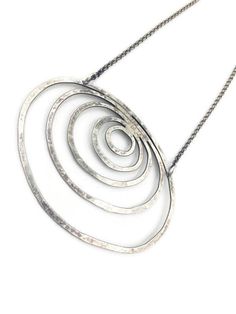 "This beautiful, simple necklace is hand fabricated from sterling silver. It is 20\" in length. The pendant measures 2\" from top to bottom and is 3\" across at widest point. An elegant piece to wear every day! The toggle is hand fabricated ." Hand Forged Silver Spiral Necklace, Minimalist Silver Spiral Necklace, Modern Silver Spiral Necklace, Rings Necklace, Asheville Nc, Colby, Simple Necklace, Asheville, Ring Necklace