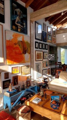 a living room filled with furniture and pictures on the wall