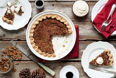 there is a pie on the table with other plates and utensils around it