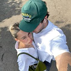 a man and woman taking a selfie in the street