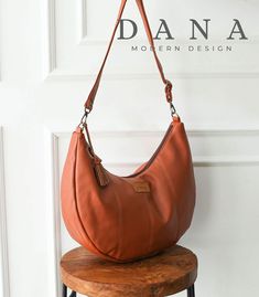 a brown purse sitting on top of a wooden stool