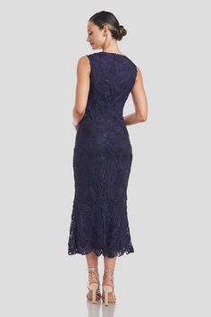 a woman in a blue dress with an open back and lace detailing on the skirt