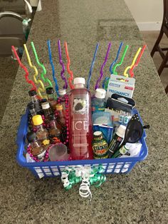 a blue basket filled with lots of items on top of a counter