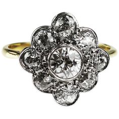 an antique diamond cluster ring in yellow and white gold