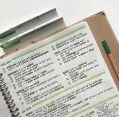 an open notebook with some writing on it next to a pen and two other items