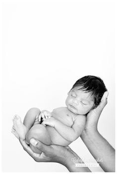 a man holding a newborn baby in his arms with the caption's name on it