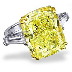 This immaculate diamond ring is a King of Jewelry exclusive. The center stone is a rare GIA certified rectangular cut 5.00-carat fancy yellow diamond accented by baguette-cut diamonds. The combination of extraordinary shape, color, and cut make this ring a one of a kind piece. This impressive diamond glows with a beautiful color hue alongside its fiery attributes for a glorious effect. split Metal : 18K White & Yellow Gold, Platinum 950 Setting Type : Prong Total Carat Weight : 5.60 Carats T Canary Yellow Engagement Rings, Yellow Diamond Wedding Rings, Canary Diamond Engagement Ring, Canary Diamond Ring, Canary Yellow Diamonds, Canary Diamond, Cushion Cut Diamond Engagement Ring, Yellow Cushion, Yellow Cushions