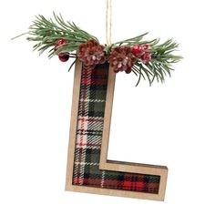 the letter l is decorated with pine cones and evergreen branches, along with red berries