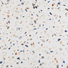 an image of a white surface with blue, brown and black spots on it's surface