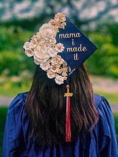 a woman wearing a blue graduation cap with flowers on it and the words mama i made it