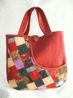 a red bag with a patchwork design on it