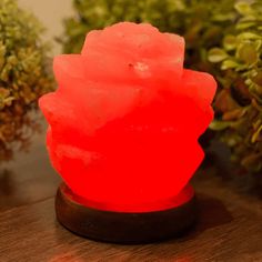 a red rock sitting on top of a wooden table