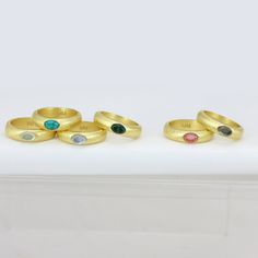 Thick band with oval stone in center Modern Gold Birthstone Ring With Gemstone, Modern Gold Gemstone Birthstone Ring, Gold Ring With Large Oval Cabochon Stone, Gold Oval Dome Ring With Gemstone, Oval Gold Plated Rings, Gold Oval Ring With Large Stone, Gold Promise Ring With Large Stone, Gold Emerald Ring With Large Oval Stone, Gold Oval Topaz Ring With Bezel Setting