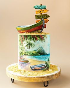 there is a cake that has been decorated to look like a boat on the beach