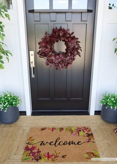 a welcome mat is on the front door