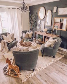 a living room filled with furniture and a baby rocking horse in the middle of it