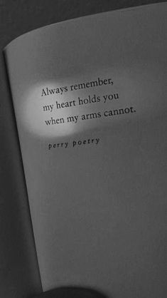 a black and white photo of a book with a quote on the page that says, always remember my heart holds you when my arms cannot't