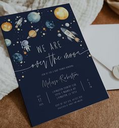 a space themed birthday party is shown with the outer planets and stars on it's navy blue card