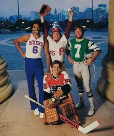 three men are posing for a photo while holding up their baseball gloves and mitts