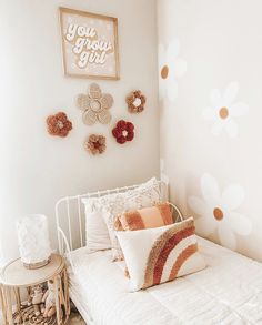 a white bed sitting in a bedroom next to a wall